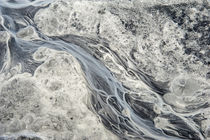 Rivulets of glacial melt water form this abstract by Danita Delimont