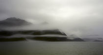 A foggy mist layers the mountains of Resurrection bay in Alaska by Danita Delimont