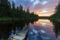 A canoe at sunrise on Little Berry Pond in Maine's Northern Forest by Danita Delimont