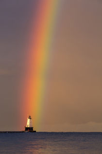 Full arcing rainbow over Lake Michigan and Ludington lightho... by Danita Delimont