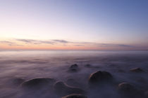 Pre-dawn light and waves wash over the rocks at Rye Harbor S... by Danita Delimont