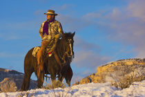 Cowboy on his Horse in the Snow; Model Released by Danita Delimont