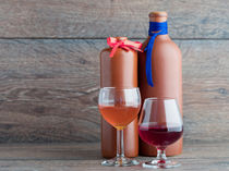 Two balsam bottle and two filled glasses on the wooden background by Sergii Petruk