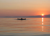 Swimmer in sunset with tropical colors. by ambasador