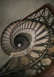 Pretty spiral staircase in beige and brown tones by Jarek Blaminsky