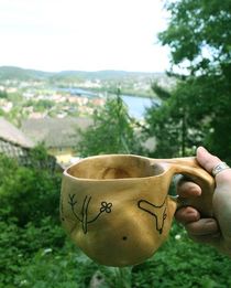 The Aku-Aku Coffee Cup by Ben Johansen