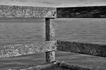 Weathered wooden fence with water black and white von Maud de Vries