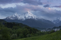 Snow covered mountain peaks of Watzmann and city Berchtesgaden with clouds during sunset, Bavaria by Bastian Linder