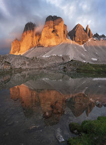Mountain lake reflecting the mountains of the Three Peaks in the European Dolomite Alps with alpenglow during sunset, South Tyrol Italy von Bastian Linder
