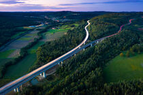 Aerial view of highway splitting aound forest hill by raphotography88