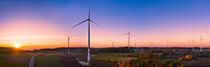 Aerial view of colorful autumn sunset between wind turbines by raphotography88