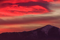 a spectacular red cloud above the mountains by susanna mattioda