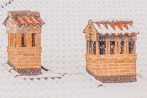 the chimneys of a house during a heavy snowfall by susanna mattioda