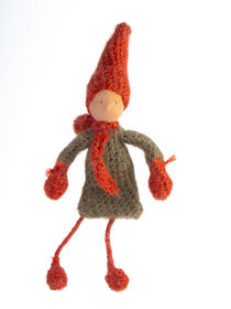 Handmade crochet autumn Gnome, with red hat and scarf, standing by Valentijn van der Hammen