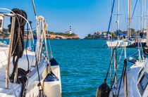 Boats and yachts with view of lighthouse in Porto Colom, Majorca by Alex Winter