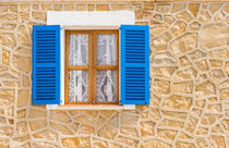 Blue open wooden window shutters and rustic wall of mediterranean house von Alex Winter