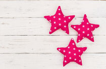 Three pink stars on white wood by Alex Winter