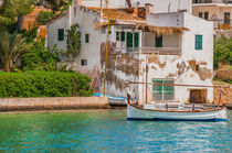 Majorca, mediterranean village with idyllic view of old fishing boat moored at the coast von Alex Winter