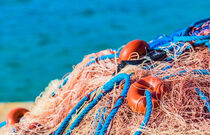 Close-up of commercial fishing net at harbor by Alex Winter