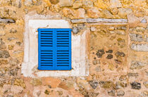 Mediterranean blue window shutters and stone wall background by Alex Winter