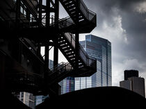 Fire Escape and Skyscrapers Against Dramatic Sky by Django Johnson