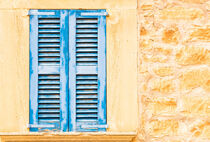 Mediterranean old blue wooden window shutters and rustic stone wall, detail view by Alex Winter