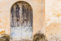 Vintage old wooden front door and broken wall of a mediterranean house by Alex Winter