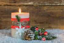 Christmas or Advent candle with decoration on snow by Alex Winter