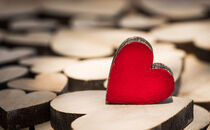 Valentine day background with wooden love hearts by Alex Winter
