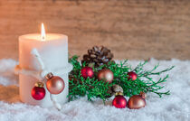Burning candle for Advent and Christmas with ornament and decoration on snow with wood background von Alex Winter