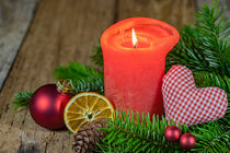 Advent and Christmas candle with red heart and traditional decoration on wood by Alex Winter