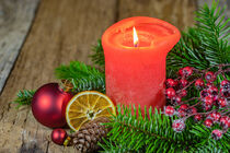 Advent and Christmas time candlelight with green and traditional decoration on wooden table by Alex Winter