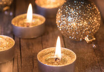 Golden Christmas candles with xmas decoration by Alex Winter