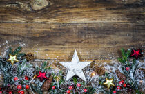 Weihnachtsdekoration mit Sternen, Zapfen, Tannenzweigen und Beeren auf Holz  von Alex Winter