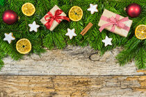 Natural christmas decoration with green fir branches and christmas gifts by Alex Winter