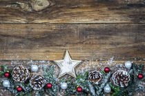 Classic Christmas decoration with xmas star, christmas balls, pine cones and fir branches on wood by Alex Winter