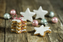 Christmas star cookies with xmas balls decoration on wooden table by Alex Winter