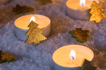 Advent or Christmas burning candles with golden xmas trees decoration on snow by Alex Winter