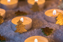 Advent and Christmas mood with candles with golden christmas trees on snow by Alex Winter