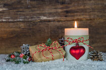 Xmas candle with christmas gift and decoration on snow by Alex Winter