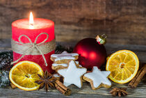 Christmas or Advent candle with cookies, orange slices, anise and cinnamon decoration by Alex Winter