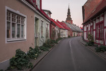 House facades and street in Ystad in Sweden during sunset by Bastian Linder