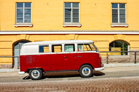 Camper-van-parked-by-a-yellow-building