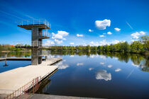 Beautiful lake with diving platform on bright summer day