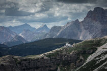 Rifugio Auronzo mountain hut during day in front of Dolomite Alps mountains at Three Peaks in Italy by Bastian Linder
