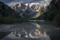 Lake Lago di Landro at Toblach with mountain chain mirroring on water surface during day by Bastian Linder