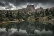 Lake Lago Limides at Passo di Falzarego in the Dolomite Alps with trees and mountain mirroring on water surface during cloudy day by Bastian Linder