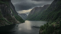 Moody fjord with mountains and waterfall of Aurlandsfjord at Gudvangen in Norway von Bastian Linder