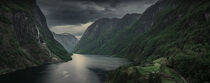 Moody fjord with mountains and waterfall of Aurlandsfjord at Gudvangen in Norway by Bastian Linder