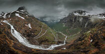 Mountain road Trollstigen winding through landscape with waterfall and valley of Trollveggen in Norway by Bastian Linder